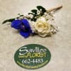 White rose and blue orchid boutonniere with baby's breath