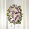 Standing floral spray with pink, white, and lavender flowers on an easel