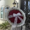 Large round bouquet of red roses with a white lace bow