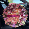 Large bouquet of pink and peach roses with lilies and carnations