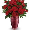 Red roses and carnations in a red glass vase