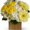 Yellow roses and pale yellow daisies in a wooden cube vase