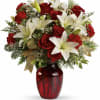 Red roses and white lilies in a red glass vase with gold accents