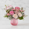 Pink roses and carnations in a pink glass vase