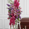 Standing funeral spray with pink lilies, roses, and purple flowers