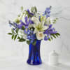 Accented by a deep blue vase, our Calming Comfort Bouquet is crafted