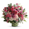 Pink and purple rose bouquet in a glass vase