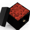 Black gift box filled with red roses