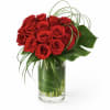 Tropical red rose floral arrangement featuring premium red roses combined with lush