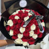 Bouquet of red and white roses wrapped in black paper