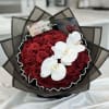 Bouquet of red roses with white orchids and dark wrapping