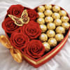 Heart-shaped box with red roses and gold-wrapped chocolates
