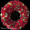 Large heart-shaped wreath of red roses on a black stand