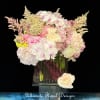 Blush Radiance is a graceful arrangement designed to captivate. Featuring cascading white