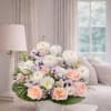 Pastel floral arrangement in a white vase with roses and tulips