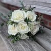 Small, handheld prom bouquet using a half dozen roses, filler and greenery.