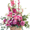 Pink lilies and roses in a woven basket