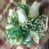 Bouquet of white roses and lilies with small white filler flowers