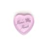 Pink heart-shaped candy with the words 'Here's My Heart' on a white background.