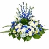 Beautiful round urn peace with blue delphinium, white roses and blue hydrangeas