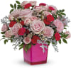 Pink and red rose bouquet in a bright pink vase