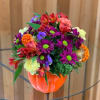 Mixed bouquet in an orange pumpkin-shaped vase