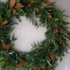 Large green foliage wreath with mixed evergreens and brown-backed leaves