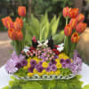 Basket arrangement with orange tulips and colorful mums featuring Mickey and Minnie figurines