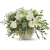 White roses and lilies arranged with succulents in a round vase