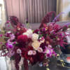 Bouquet of white roses and magenta orchids with burgundy blooms