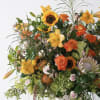 Large mixed bouquet with sunflowers, lilies, roses, and protea