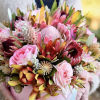 Pink and burgundy bouquet with protea and roses