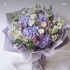 Lavender bouquet with roses and hydrangeas wrapped in lilac paper