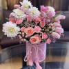 Pink and white bouquet in a pink hatbox with tassel cord