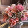 Pink and peach rose bouquet with baby's breath and berry accents