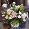 White and pink floral arrangement in a white vase