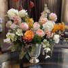 Mixed pastel flower arrangement in a silver vase