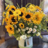 Sunflower bouquet in a striped round box with white accent flowers