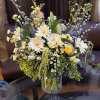 Mixed bouquet of white and yellow flowers in a glass vase