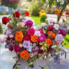 Colorful mixed bouquet of roses and other flowers on a table