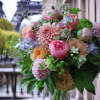 Bouquet of pink, peach, and lavender flowers with greenery