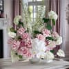 Pink and white floral arrangement in a white vase