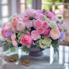 Pink and peach rose arrangement in a dark vase