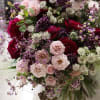 Bouquet of pink and burgundy roses with purple filler flowers