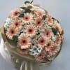 Soft peach gerbera daisies take center stage in this hand-tied flower arrangement