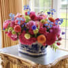 A vital and bright arrangement in oriental vase with vibrant colors is