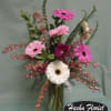 Pink and white gerbera daisies in a clear glass vase