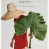 Book cover with a woman in a red dress and a large green leaf hat
