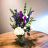 Tall mixed bouquet in a glass vase with white and purple flowers