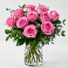 Pink roses arranged in a clear glass vase